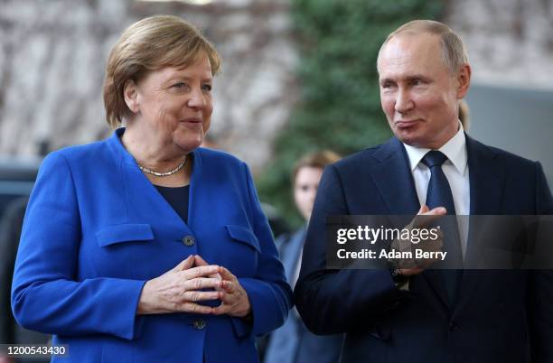 German Chancellor Angela Merkel greets Russian President Vladimir Putin as he arrives for an international summit on securing peace in Libya at the...