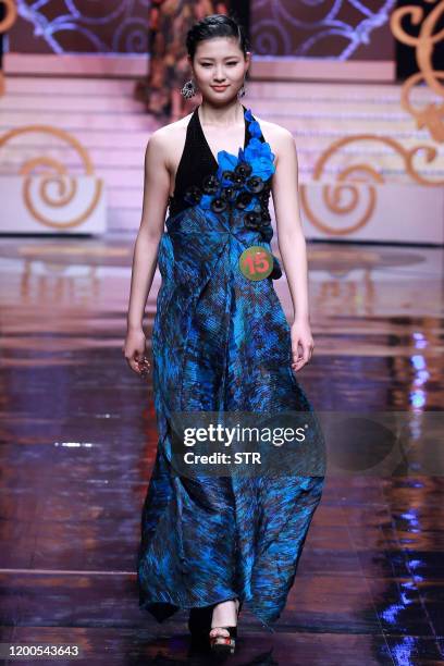 Chinese model parades during the 6th China Super Model contest final at the close of the China Fashion Week in Beijing on March 31, 2011. The...