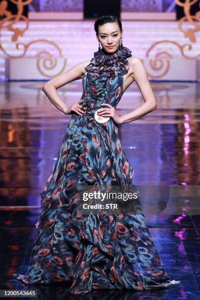 Chinese model parades during the 6th China Super Model contest final at the close of the China Fashion Week in Beijing on March 31, 2011. The...