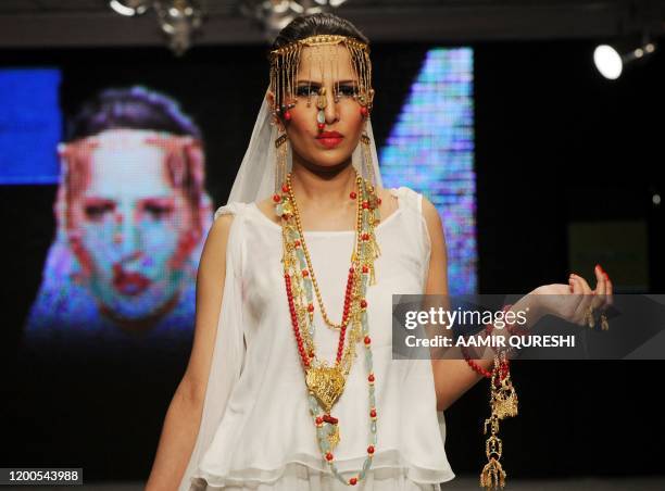 Pakistani model presents a creation by Pakistani designer Shafaq Habib during the first day of Islamabad Fashion Week in Islamabad on January 27,...