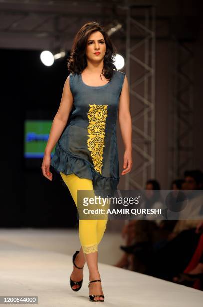 Pakistani model presents a creation by Pakistani designer Hameeda during first day of Islamabad Fashion Week in Islamabad on January 27, 2011. Some...