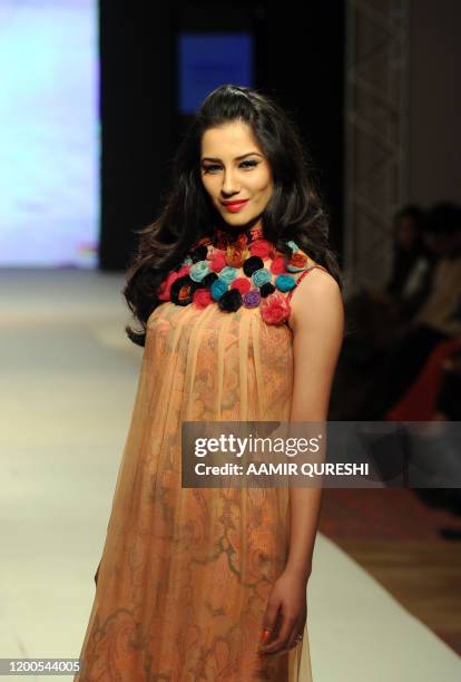 Pakistani model presents a creation by Pakistani designer Hameeda during first day of Islamabad Fashion Week in Islamabad on January 27, 2011. Some...