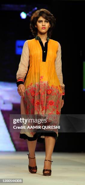 Pakistani model presents a creation by Pakistani designer Hameeda during first day of Islamabad Fashion Week in Islamabad on January 27, 2011. Some...