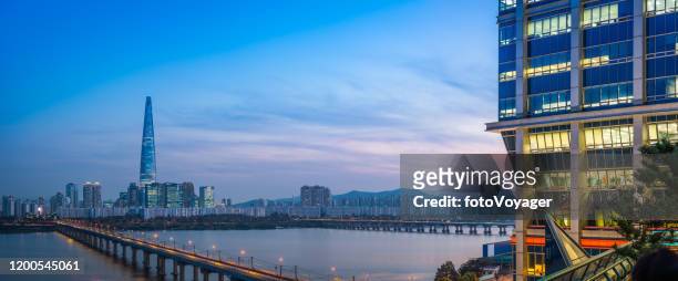 futuristic skyscraper cityscape panorama illuminated night han river seoul korea - lotte world tower stock pictures, royalty-free photos & images