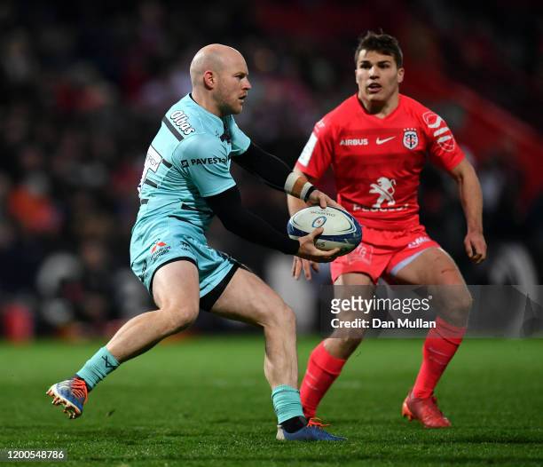 Joe Simpson of Gloucester looks for a pass under pressure from Antoine Dupont of Toulouse during the Heineken Champions Cup Round 6 match between...