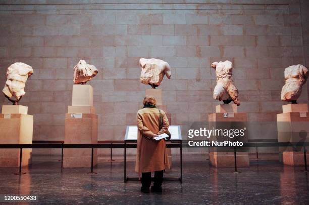 Woman looks at a section of the Parthenon Sculptures exhibit in the British Museum in London, England, on February 13, 2020. The museum, one of...