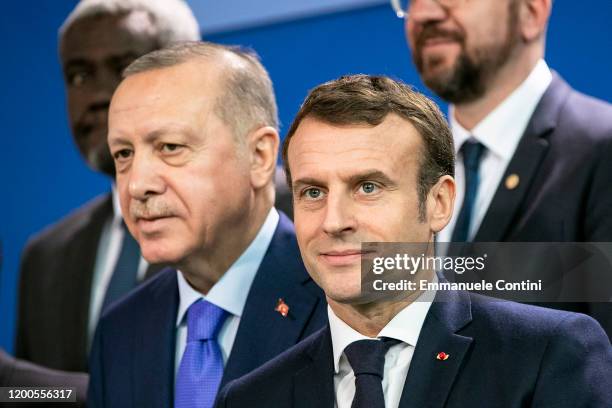 French President Emmanuel Macron and Turkish President Recep Tayyip Erdogan are pictured during a family picture at the Chancellery on January 19,...