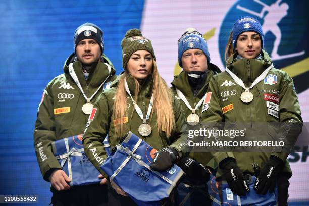 Italy's Dominik Windisch, Italy's Dorothea Wierer, Italy's Lukas Hofer and Italy's Lisa Vittozzi pose with their silver medal on the podium after...