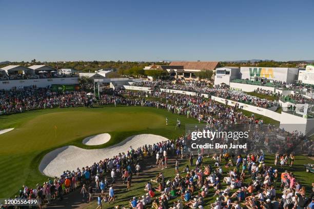 Fans watch play around the 18th green during the final round of the Waste Management Phoenix Open at TPC Scottsdale on February 2, 2020 in...