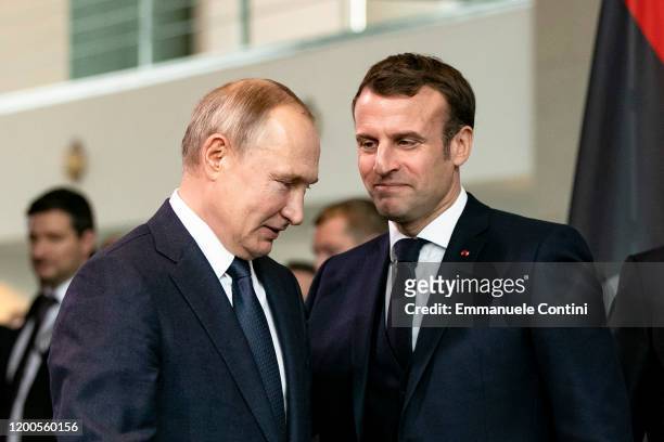 French President Emmanuel Macron and Russian President Vladimir Putin arrive for a family picture at the Chancellery on January 19, 2020 in Berlin,...
