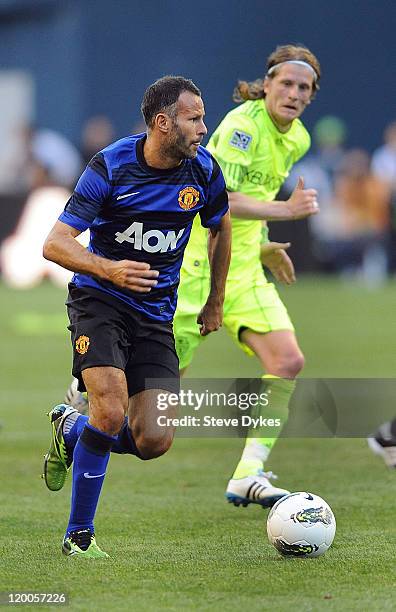 Ryan Giggs of Manchester United brings the ball up the field against the Seattle Sounders FC during the second half of the game at CenturyLink Field...