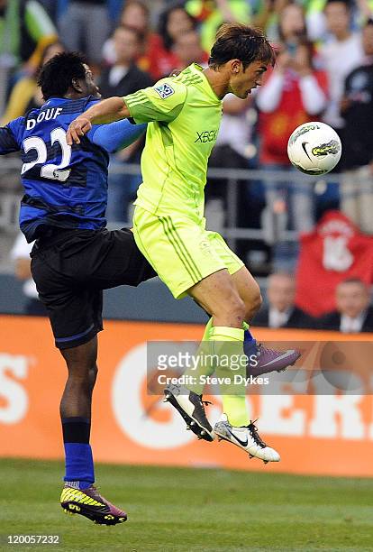 Mame Biram Diouf of Manchester United and Patrick Ianni of the Seattle Sounders FC go up in the air after a ball during the second half of the game...