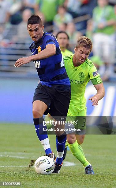 Federico Macheda of Manchester United battles for a ball with Jeff Parke of the Seattle Sounders FC during the first half of the game at CenturyLink...