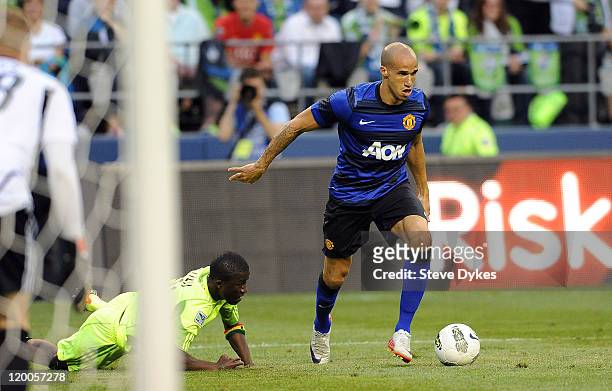Gabriel Obertan of Manchester United dribbles the ball around Michael Tetteh of the Seattle Sounders FC during the second half of the game at...