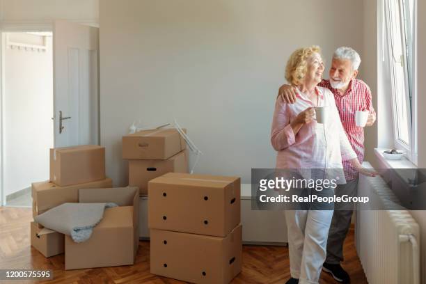 senior couple in new home - senior moving house stock pictures, royalty-free photos & images
