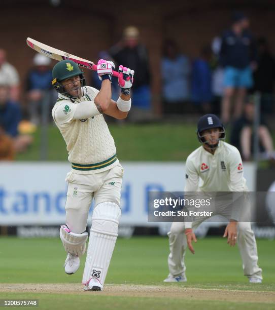 Faf du Plessis of South Africa tucks into a short ball as England captain Joe Root looks on during Day Four of the Third Test between South Africa...