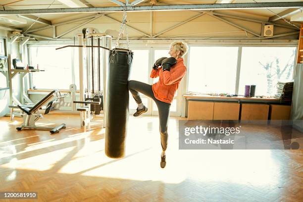 senior woman boxing ,knee punching - female boxer stock pictures, royalty-free photos & images