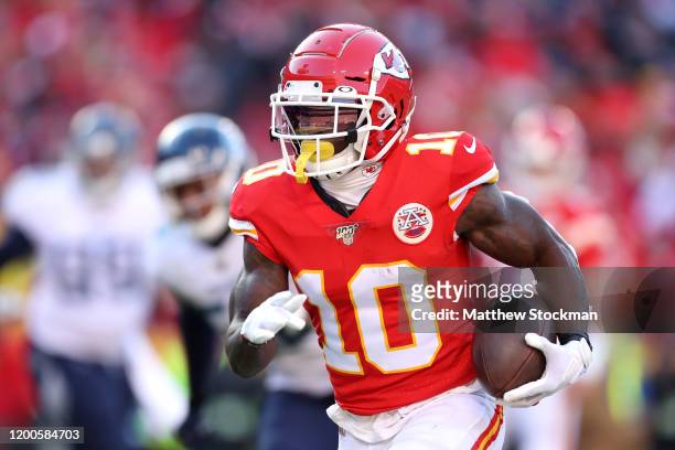 Tyreek Hill of the Kansas City Chiefs runs for a 7 yard touchdown in the first quarter against the Tennessee Titans in the AFC Championship Game at...