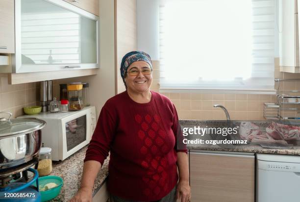 senior woman working  in the kitchen - turkish ethnicity stock pictures, royalty-free photos & images