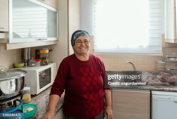 senior woman working in the kitchen - turkish ethnicity stock pictures, royalty-free photos & images