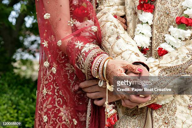 close up on hands of a married indian couple - bangle ストックフォトと画像