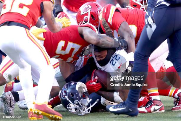 Derrick Henry of the Tennessee Titans loses his helmet as he's tackled in the first half by Anthony Hitchens of the Kansas City Chiefs in the AFC...