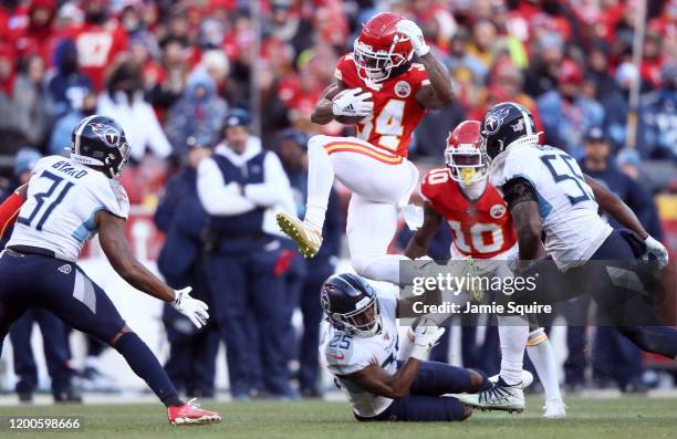 Darwin Thompson of the Kansas City Chiefs runs with the ball and jumps over Adoree' Jackson of the Tennessee Titans in the second half in the AFC...