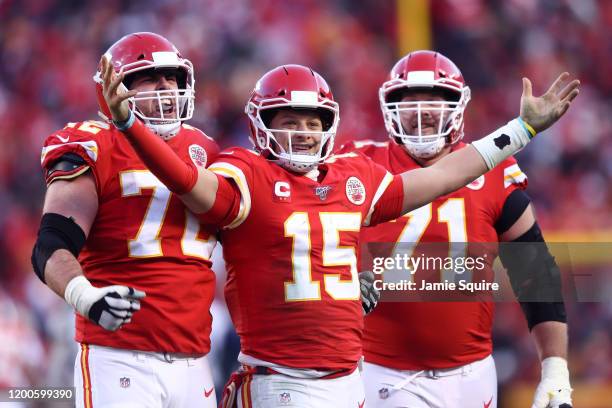 Patrick Mahomes of the Kansas City Chiefs reacts with teammates Eric Fisher and Mitchell Schwartz after a fourth quarter touchdown pass against the...