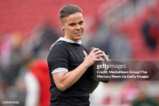 San Francisco 49ers offensive assistant Katie Sowers throws passes on the field before their NFC Championship game against the Green Bay Packers at...