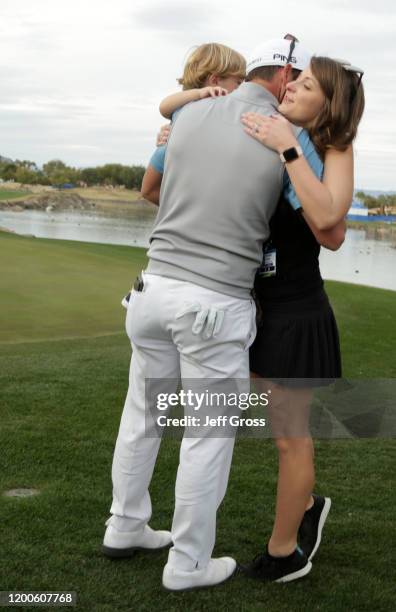 Andrew Landry celebrates with his wife Elizabeth and son Brooks after putting in to win on the 18th green during the final round of The American...