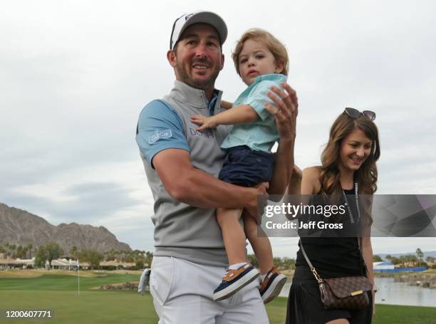 Andrew Landry celebrates with his wife Elizabeth and son Brooks after putting in to win on the 18th green during the final round of The American...