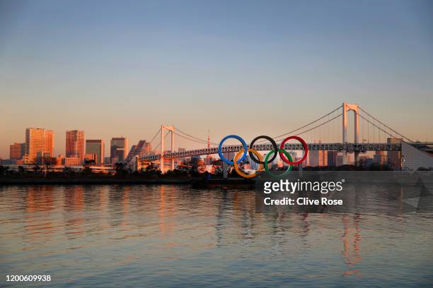 The Olympic rings are seen in front of Tokyo's iconic Rainbow Bridge and Tokyo Tower at Odaiba Marine Park on January 20, 2020 in Tokyo, Japan.