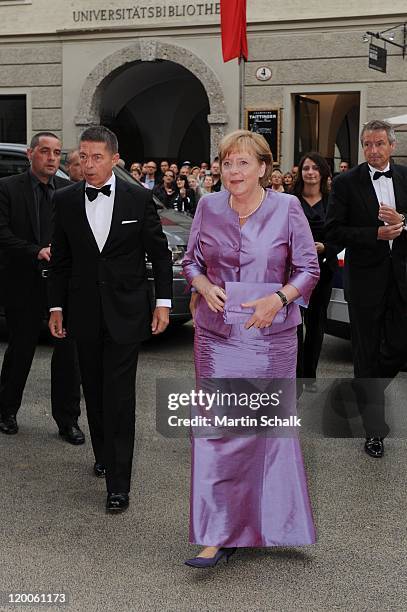 German Chancellor Angela Merkel and husband Joachim Sauer attend the 'Die Frau ohne Schatten' Premiere at the great festival hall during the Salzburg...