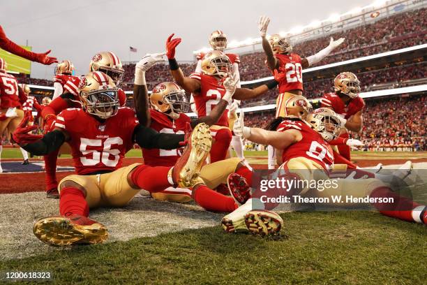 The San Francisco 49ers defense celebrates after an interception by Emmanuel Moseley in the first half against the Green Bay Packers during the NFC...