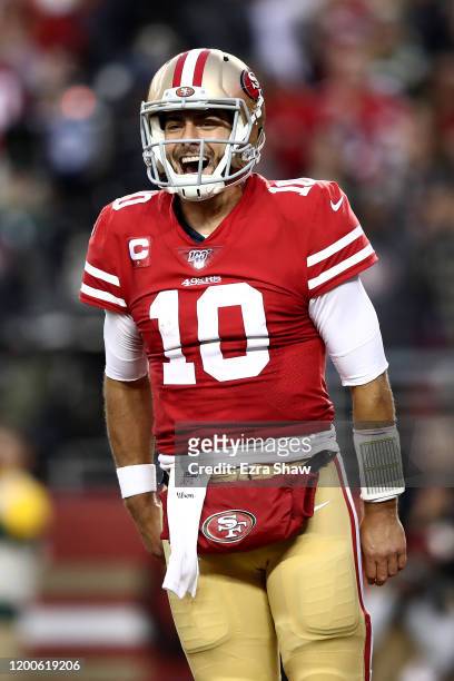 Jimmy Garoppolo of the San Francisco 49ers celebrates a touchdown by Raheem Mostert in the second quarter against the Green Bay Packers during the...