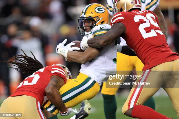 Jamaal Williams of the Green Bay Packers is tackled on a run by Jaquiski Tartt of the San Francisco 49ers during the NFC Championship game at Levi's...