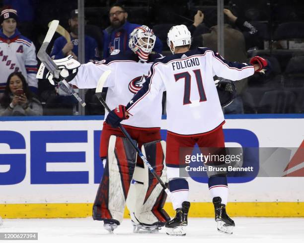 Matiss Kivlenieks and Nick Foligno of the Columbus Blue Jackets celebrate their 2-1 victory over the New York Rangers during Kivlenieks' first NHL...