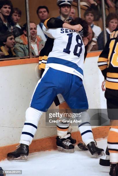 Ron Sedlbauer of the Toronto Maple Leafs fights against Brad McCrimmon of the Boston Bruins during NHL game action on March 11, 1981 at Maple Leaf...