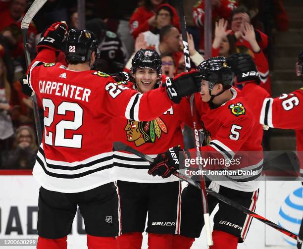 Patrick Kane of the Chicago Blackhawks celebrates his 1000th career point on an assist on a goal by Brandon Saad in the third period with teammates...