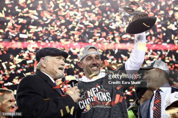 Head coach Kyle Shanahan of the San Francisco 49ers of the San Francisco 49ers celebrates with the George Halas Trophy after winning the NFC...