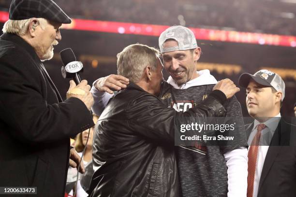 Head coach Kyle Shanahan of the San Francisco 49ers celebrates with his father, Mike Shanahan, after winning the NFC Championship game against the...