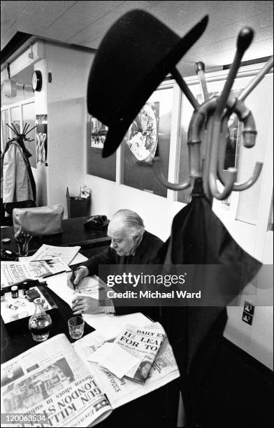 Cartoonist Osbert Lancaster at work at his desk in the 'Daily Express' office, 1974.