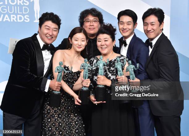 Parasite" cast Song Kang-ho, Park So-dam, director Bong Joon-ho, Lee Jung-eun, Choi Woo-shik, and Lee Sun-kyun pose in the press room with the trophy...