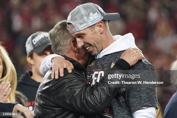 Head coach Kyle Shanahan of the San Francisco 49ers celebrates with his father, Mike Shanahan, after winning the NFC Championship game against the...