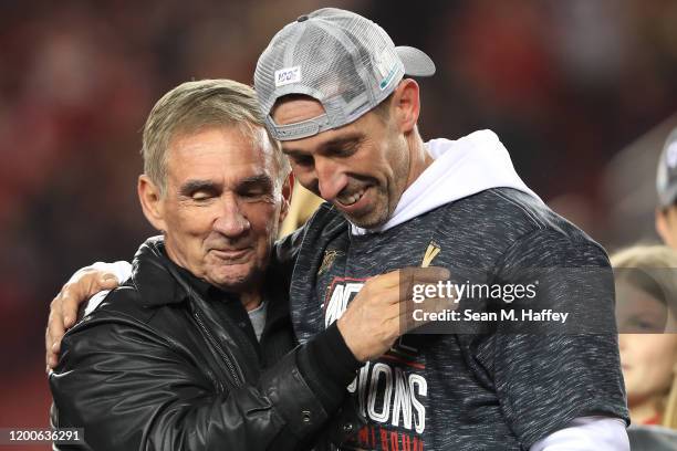 Head coach Kyle Shanahan of the San Francisco 49ers celebrates with his father, Mike Shanahan, after winning the NFC Championship game against the...