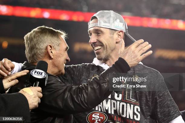 Head coach Kyle Shanahan of the San Francisco 49ers celebrates with his father, Mike Shanahan, after winning the NFC Championship game against the...