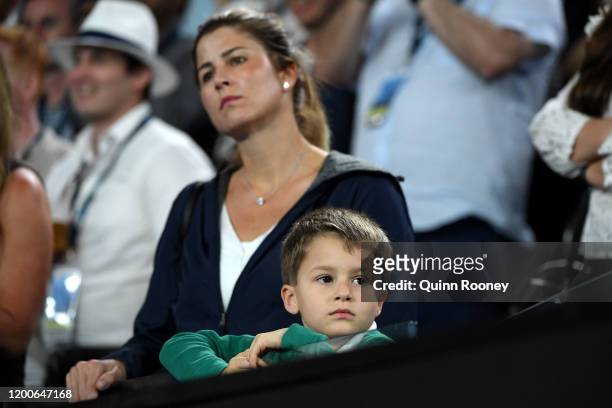 Mirka Federer, wife of Roger Federer of Switzerland and her son watch from the stands during her husband's Men's Singles first round match against...