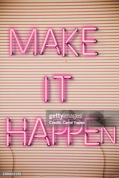 make it happen text in neon lights - new challenge stockfoto's en -beelden