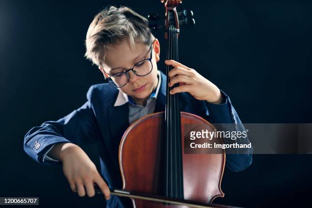 little boy and playing cello - cello stock pictures, royalty-free photos & images