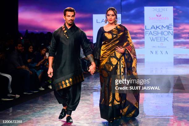 Bollywood actors Karan Singh Grover and Bipasha Basu present creations by Sanjuktta Dutta during the Lakme Fashion Week 2020 Summer/Resort fashion...